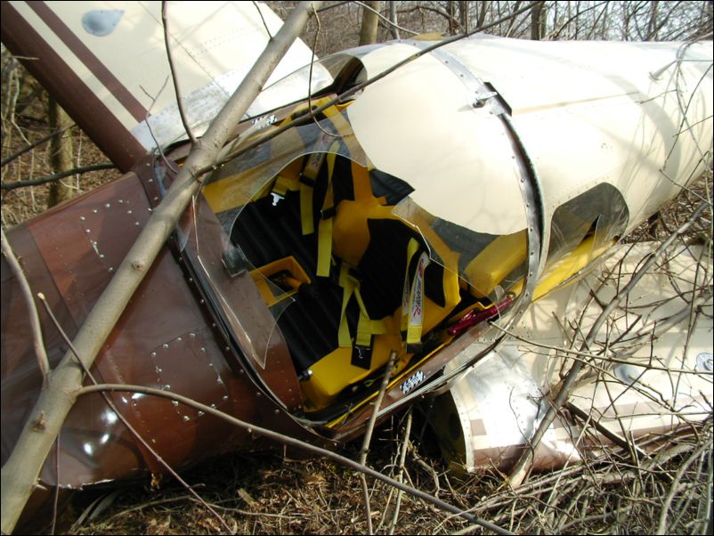 Left wing folded under, but still attached to aircraft.