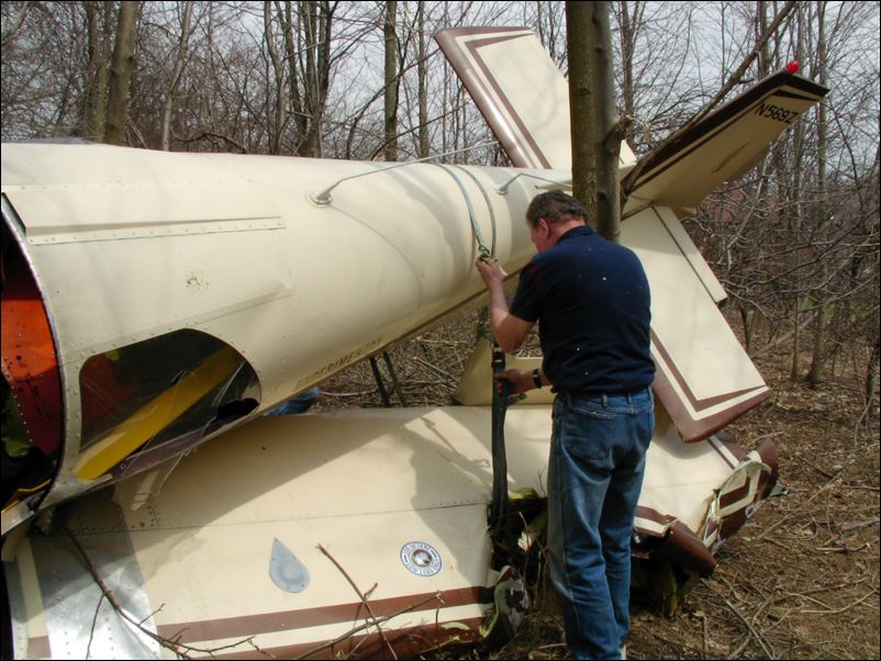 Tie left wing to fuselage.