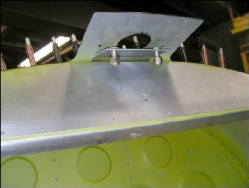 This shows the rear seatbelt attachment bracket in front of the bagage area.