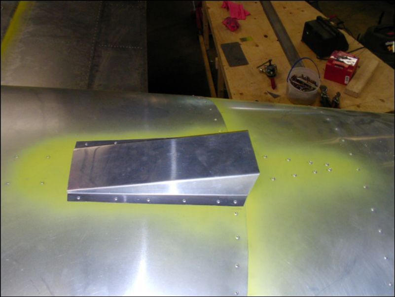 Rivet air vent cover to top of fuselage.
