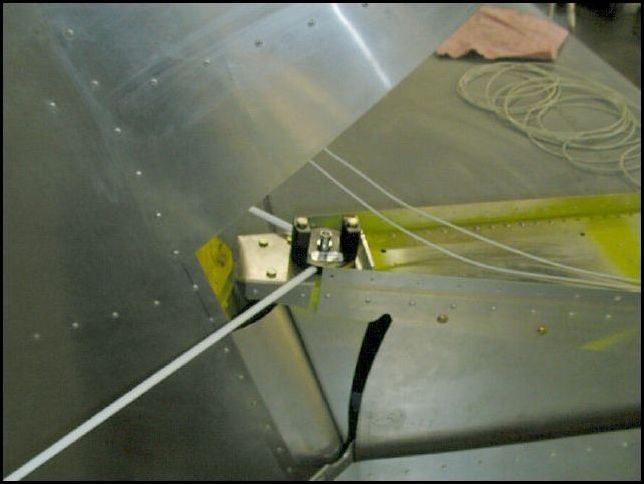 Attach VOR antenna in front of the rudder.  I made a spacer the same thickness as the rudder hinge and installed one bolt through the upper rudder hinge and the other through my spacer and the top of the tail section.