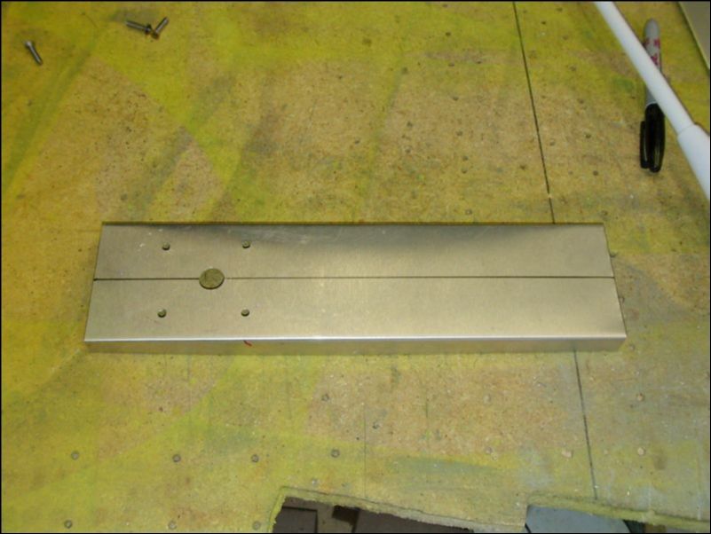 Fabricate a mounting plate for both COM antennas.