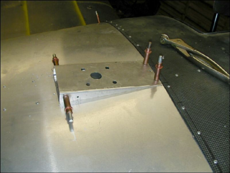 Drill and cleco one of the GPS mounting plates to the top of the fuselage next to the canopy.