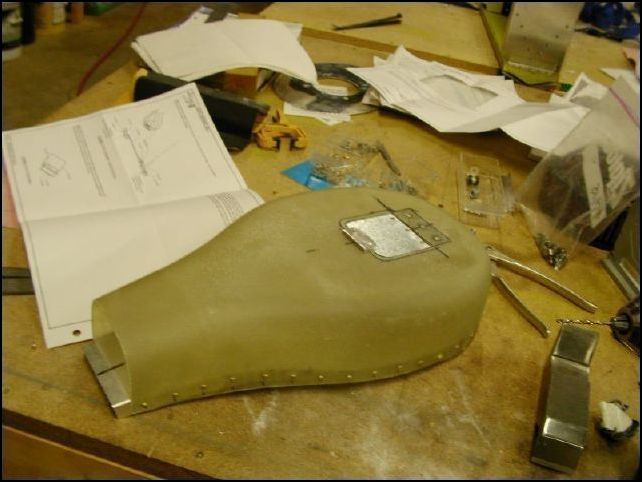 Then I cut a hole in the fiberglass airbox and riveted a filter bypass flap to a rubber hinge which is riveted to the bottom of the airbox.  The front of the flap is held down with a small magnet which is riveted to the front of the bypass hole.  This allows the flap to open if the filter is not allowing enough air to flow.  I will also add a small IR sensor to the airbox so that I will know if the flap is opening.  That would mean that it is time to change the filter.