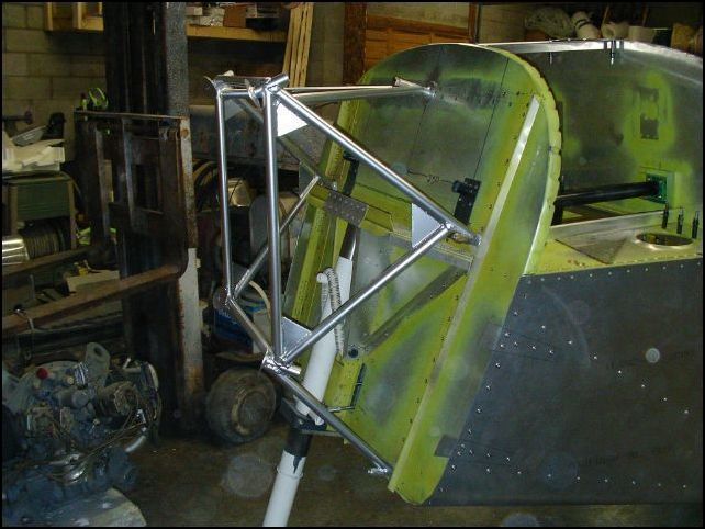 Bolted engine mount to firewall.