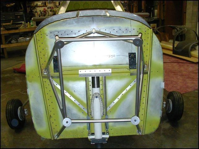 Bolted engine mount to firewall.