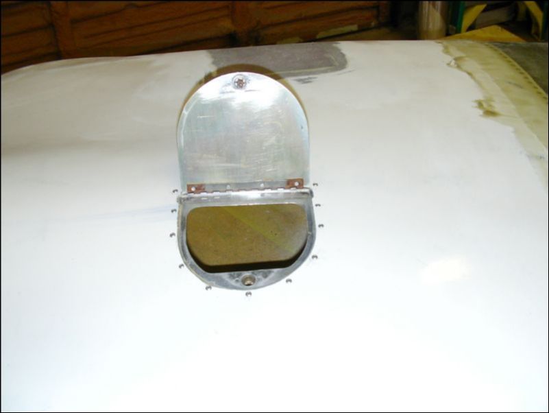 Strip the old paint from the oil access door and rivet it to the top cowling.