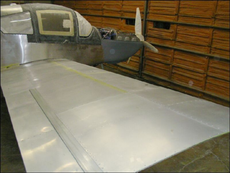 Prep aircraft for primer by sanding all surfaces lightly and masking off everything that we don't want paint on.