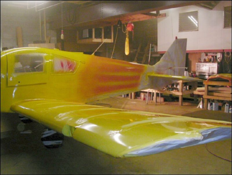 Wipe aircraft down one more time with surface cleaner and paint entire aircraft yellow.  Then mix a little red with the yellow and spray an orange fade on the scallops.