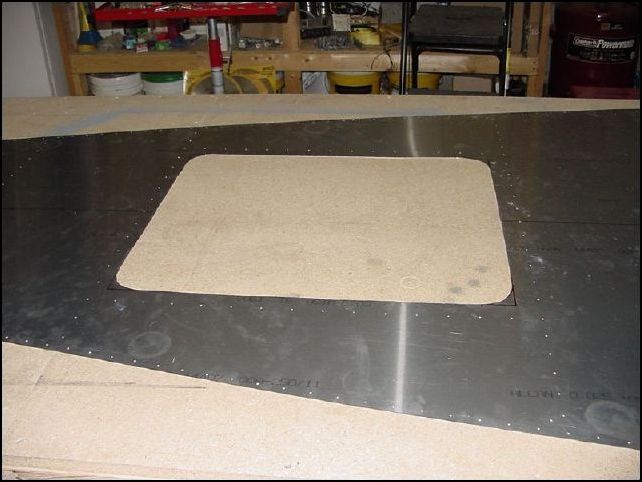 I used my pneumatic nibbler to cut out the access hole and then trimmed with hand snips.