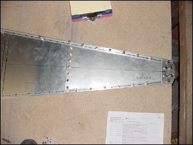 Line the longeron up with the edge of the rear bottom skin, drill and cleco in place.  Don't worry about the fact the rest of the longeron does not line up with the skin.  You will be able to pull it into place after you cleco the rear section.