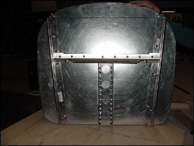 Drill engine mount holes from back side through the pilot holes made earlier.