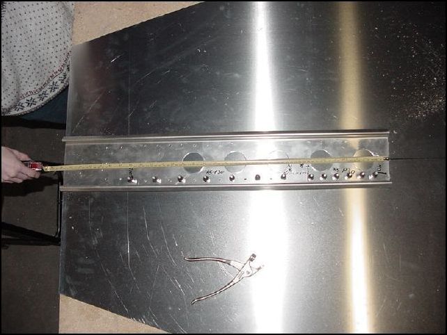 Mark out rivet holes, drill and cleco in place.  To mark the rivet holes measure 10 mm in from each side, then measure 40mm from the rear of the stiffener and mark for A5 P30 from the 40mm mark to 190mm.  Then measure 250mm from the rear of the stiffener and mark rivet holes A5 P30 from this mark to 610mm.  This will give you a total of 19 rivet holes for each side.  NOTE: in this image I have 21 holes on each side, not 19.  You should have 19 at this time on each side.  See note on image 05 for details of why I have 21.