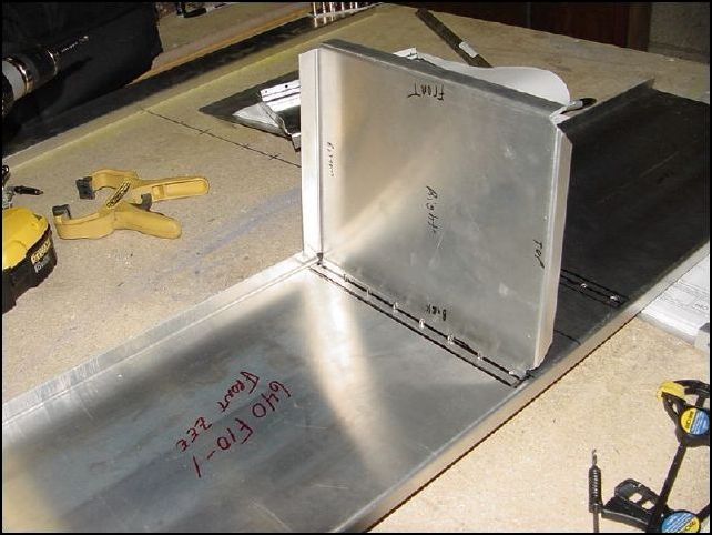 This image shows one side wall clecoed to the forward Z.  Notice that I have marked top, bottom, front, and back.  The top is 90 degrees to the back and the bottom angles up toward the front.  On the IPL they have these marked as left and right, but the one marked left is actually what I would call the right one and the one marked right is actually left.  This threw me for a bit since I would call left the left side of the aircraft but it seems these parts are marked left as if you were looking at the aircraft from nose to tail.  Strange huh.