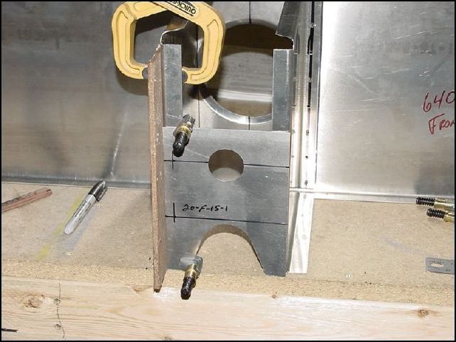 Position 20-F-15-1 to the front of the side walls and flush to the bottom of the side walls.  Drill one hole at the 35 mm mark and one at the 95 mm mark for each side.  I could not find any info as to what size rivet holes to drill so I drilled mine for A5 rivets.