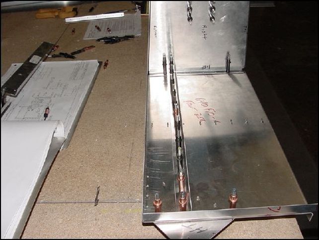 Drill and cleco in place A5 P45.  I drilled the two outside holes from the rear through the wing attachment and dirlled them as A4 since the drawings show the wing attachment as AD4 not A5.  I also drilled the center hole as A4 since the rest of the rivets in the standard L are A4 and this one goes through that L.