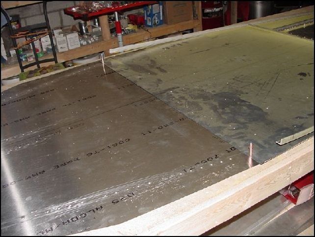 Slide the forward floor assembly under the rear floor.  Overlap up to the 18mm mark.  Make sure that the center lines match and that you are centered on your table.  Drill the two holes into the front skin.