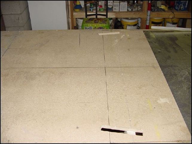 The IPL now says to re-install the center spar.  However this would not be logical since all you do is install it and then remove it for this step.  So, save yourself the time and just do this instead.  Re-install the two extrusions 640-F-24-4 to the front bottom skin.  Position the front bottom skin to the rear bottom skin and then mark on the table where the extrusions are touching the table on both sides.  Now remove the skin and cut into the table about 100mm long, 25mm wide and about 20mm deep.  I just cut mine all the way through the table... it was easier and will not hurt a thing.  This also allowed me to not worry about bending the extrusions at this time.  That will be much easier to later once more parts are holding everything in place.