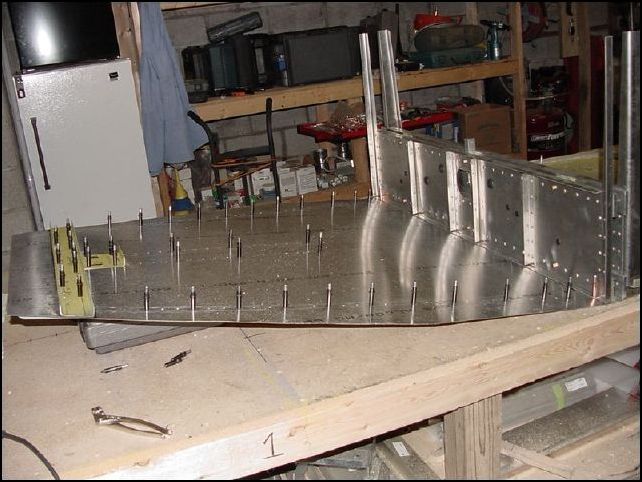 Cleco the front floor, rear floor, and center channel togther with the two holes drilled before.  Then raise the front of the front skin about 190 mm.  We will get more exact later, for now just make sure that your extrusions don't bind on your table.