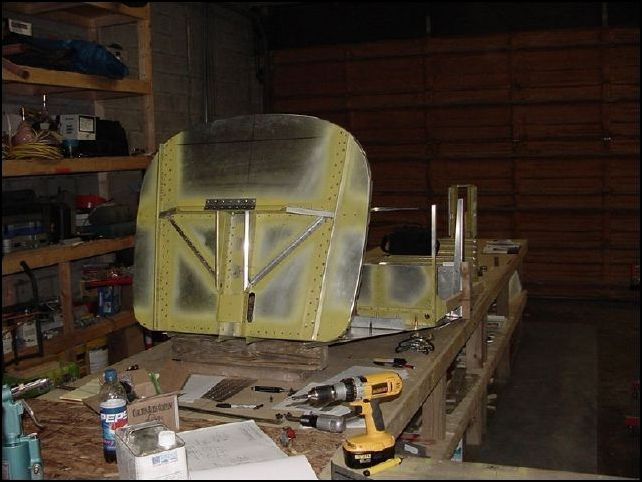 Position the firewall to the front bottom skin.  I will try to take a more detailed picture of this since this is a bit tricky.  I spent a lot of time searching through the drawings to figure out how the firewall should connect to the skin.  I think I have it figured out.  The front bottom skin slides in between the lower horizontal firewall angle and the bottom lip of the firewall.  This also means that the bottom lip of the firewall goes between the skin and the center floor channel and also between the skin and the longerons.  I am not going to drill and rivit this section until I can confirm with Zenair that this is correct.