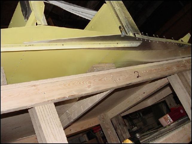 Drill A5 rivet holes through the longeron doubler from the top side through the holes for the longerons.  Then mark and drill A5 P100 rivet holes around the edges of the doubler from the bottom.