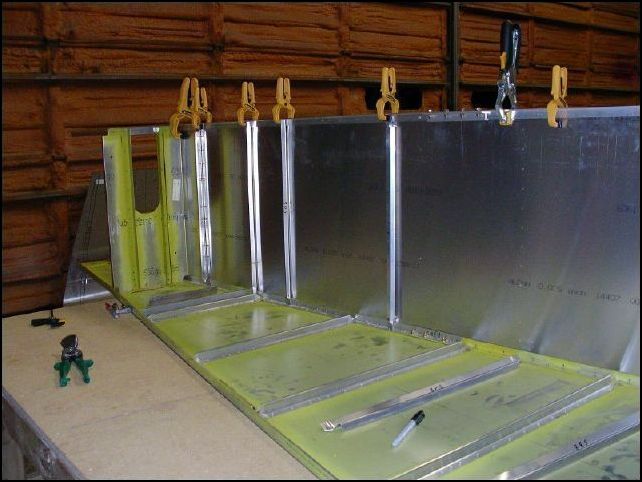 Draw a center line on each L and Z and then have your helper hold them in place.  Line up the center line through the holes in the side skin.  Drill and cleco in place.