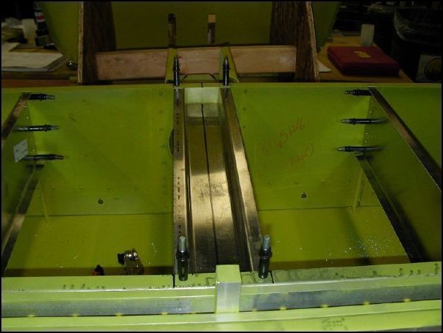 Position 640-F-11-4 (center channel) between the front and center spars.  Line up on center line.  Drill and cleco the four corners AF-5.