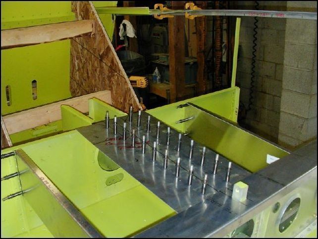 Position 640-F-8 (center seat panel) on top of the center channel.  Drill and cleco in place.  DO NOT DRILL AT THE MAIN SPAR.  This image also shows the seat panel installed over the main spar.  I should have taken a picture before doing this but forgot.