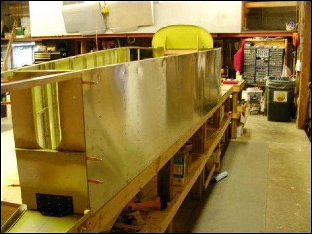 Riveted lower right side skin to fuselage.