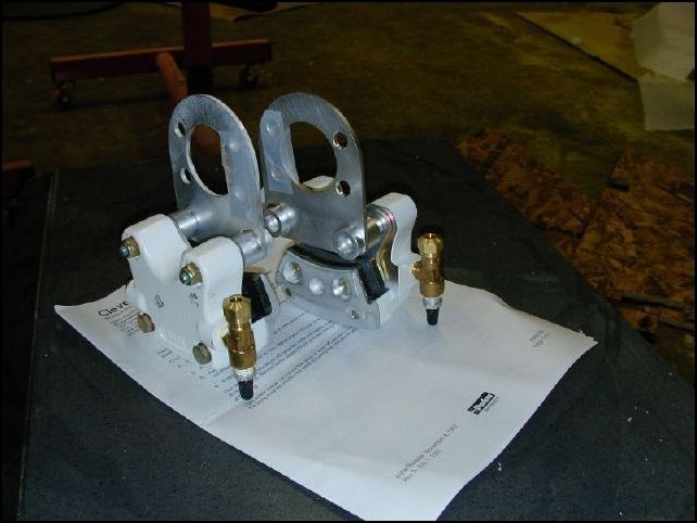 Install brake line fittings to brake calipers.