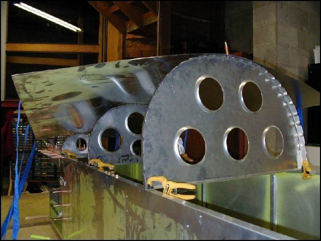 Position bulkheads to the fuselage.  Once again I did not follow the IPL on this step.  I found it was MUCH easier to do it my own way.  First I drilled the center holes in the rear top skin for bulkheads 7, 6, and 5.  then I drilled the center hole in those bulkheads and clecoed them to the skin.  Then I positioned the three bulkheads with the skin clecoed to the fuselage.  The rear bulkhead sits on top of the HT frame.