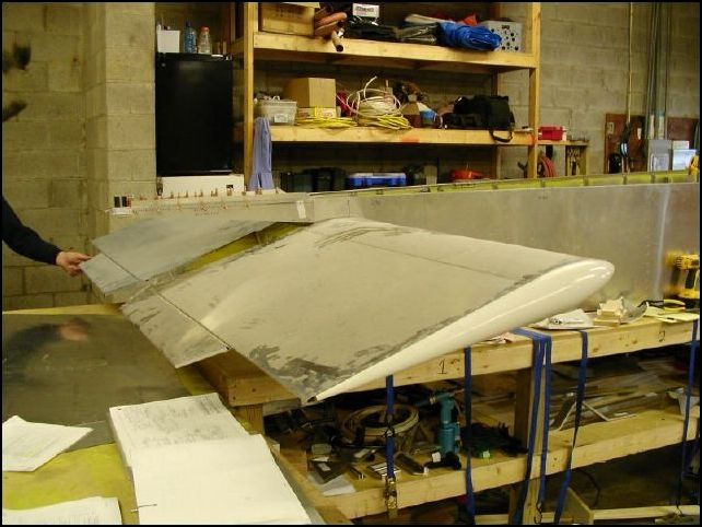 Another view of the rear wing bolted to the fuselage.  Now I have to remove it and continue building.  I guess I could have cleaned the dust off of it before taking the picture.  By the way, the wing is .01 degrees off level, that is close enough for me!  This shows that if you are SURE that you install the hinge brackets and attachment brackets as shown in the drawings that the wing will fit perfectly!  I have a video of the wing on this site.  See the video section.