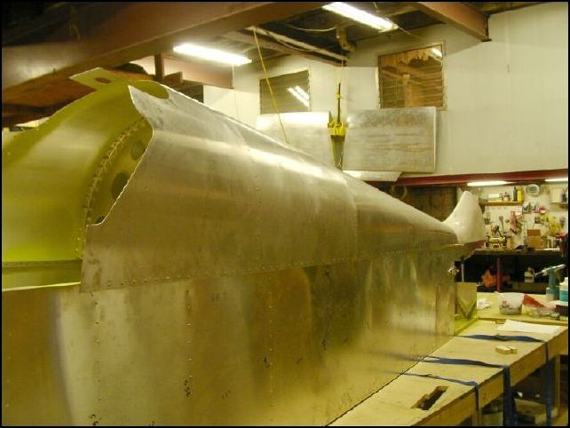 Rivet bulkheads and top skins to fuselage.