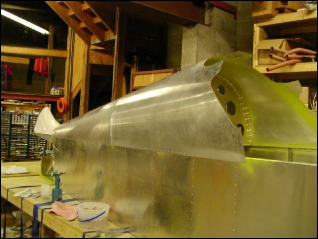 Rivet bulkheads and top skins to fuselage.