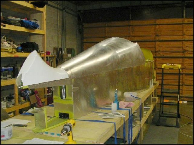 Rivet bulkheads and top skins to fuselage.