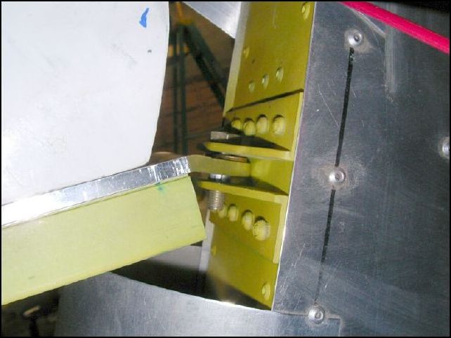 Drilled 1/4 inch hole in top hinge mounts of rudder and 5/16 inch hole in top rudder hinge of fuselage.  Installed bushing in to fuselage rudder hinge, placed washer over bushing and attached the rudder to the fuselage.