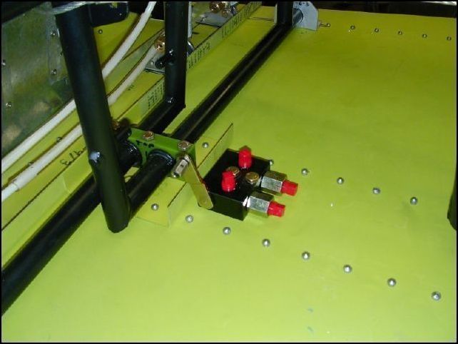 Zenair did not design this aircraft to have a parking brake.  I wanted one so I installed a parking brake valve from Aircraft Spruce to the cabin floor with two rivnuts and two an3-12a bolts.