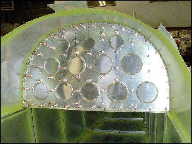 Attach the cover to the back of bulkhead 4 and drill rivet holes A4 P40 around the edges and between lightening holes.  Cleco as you drill.