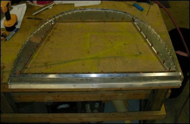 Cut out the baggage compartment center.  Make this cut-out slightly larger than the inside of the L's so that the radius of the L's will be past the cut-out.  Drill and cleco the L's to the bulkhead A4 P40.