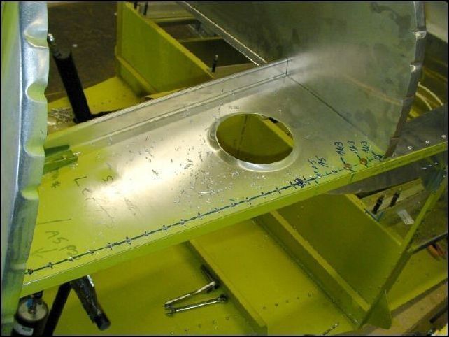 Deburr, clean, prime and rivet the front horizontal panels to the top longerons.