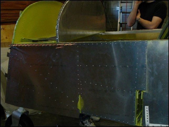 Rivet the fuselage lower front skins.  DO NOT BEND AROUND BOTTOM AT THIS TIME and do NOT rivet at the top front where the canopy will overlap.