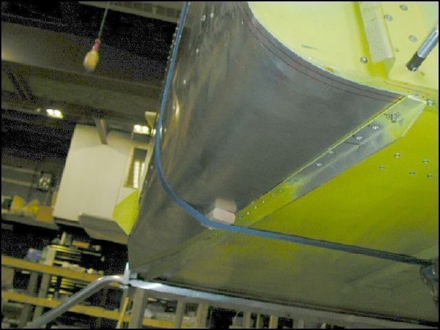 Put a strap around front skins and bend skins around bottom of fuselage.  You will need to trim the skin so that it will line up with the edge of the lower longerons.