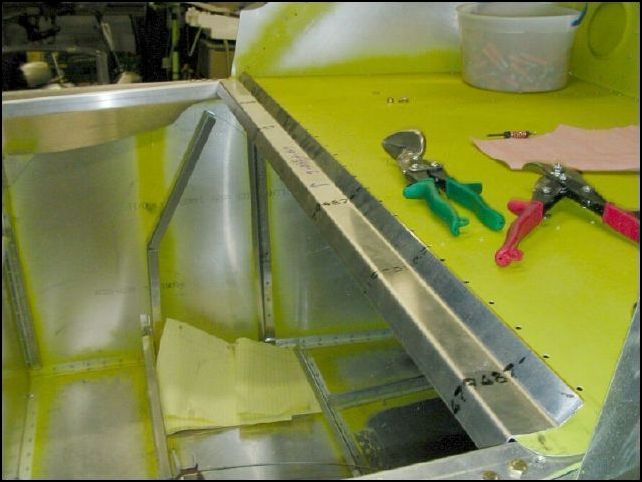 Remove flap motor bracket from bulkhead 3.  Position the bulkhead to the fuselage and then trim the rear seat top Z to fit between the longeron doublers.  Mark the location of this Z on the bulkhead.