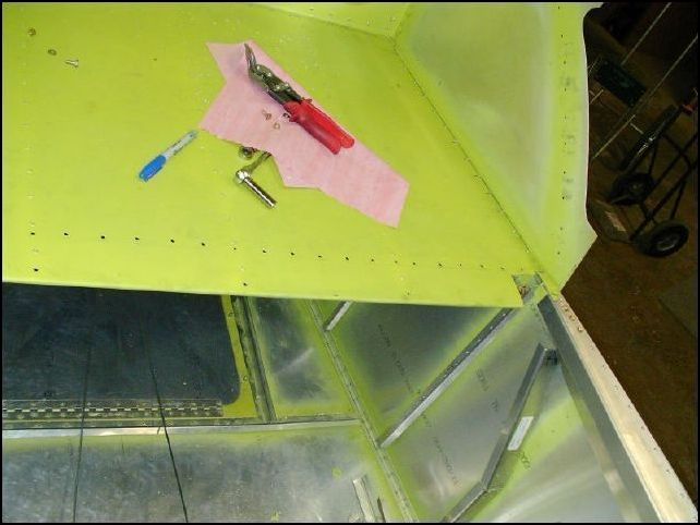 Cut the baggage floor to clear the flap motor bracket.