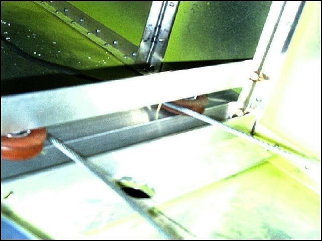 Bolt the pulley assembly to the fuselage skin Ls .