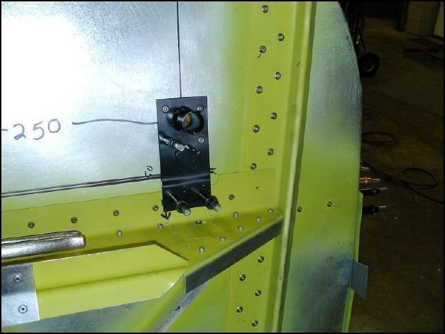 Measure 250 mm from center line of firewall and 65 mm up from center Z.  The drawings show this as 50 mm up on one page and 60 mm up on another and yes, you guessed it, 65 mm up on yet another page.  Again, trust me... it needs to be 65 mm up.  Drill 1 1/4 inch holes.  Slide the control arm through the hole and mark the location of the second hole.  Remove control rod, drill second hole and insert the control rod.  Then drill, cleco, clean, prime, and rivet in place with A5 SS rivets.