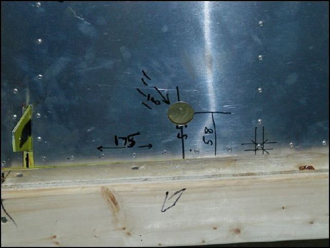 Cut 1 1/8 inch hole then use a deburr tool so that the flap motor rod fits nicely without rubbing on the skin.