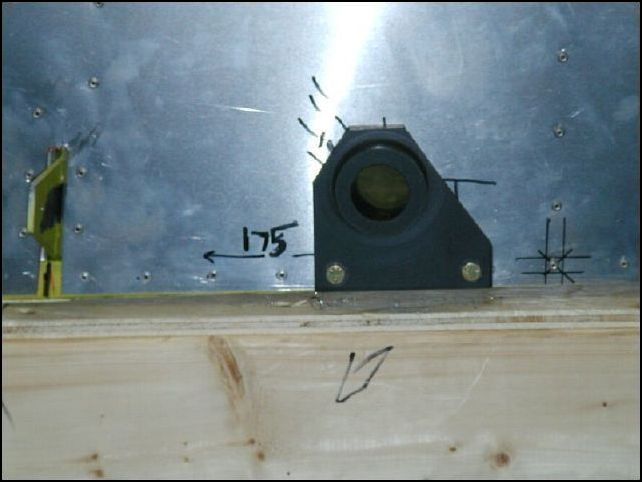 Position the flap rod bearing to the outside of the fuselage over the hole.  Drill and bolt the bearing to the lower longeron.  Repeat for other side of fuselage.