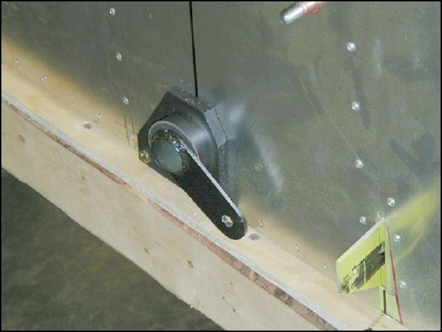 Install 20-C-15-8 (flap lever long) through the co-pilots side flap control bearing.