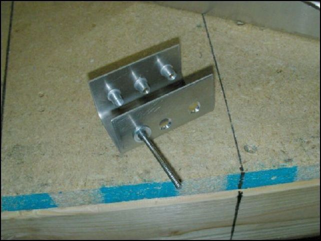 This took FAR too long, but it had to be done.  This image is one of the front seat belt attachment brackets (20-V-4-5).  They SHOULD simply slide in to the channel at the sides of the center spar and then be riveted in place.  However they do not fit because they are the same size as the channel.  So first I had to put it in a vise and bend it to make it smaller, and then bend the sides back out.  Then I tried to rivet it but I can not get my rivet gun in to the rear side of it since my front skins are already riveted on.  SO, I installed rivnuts so that I can bolt them in place.